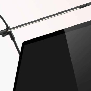 The Superlight Floor is a sleek, thin LED light bar that attaches to the top of a computer monitor, providing overhead illumination.