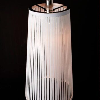The Solis pendant lamp features vertical slats that emit a warm glow against a dark background.