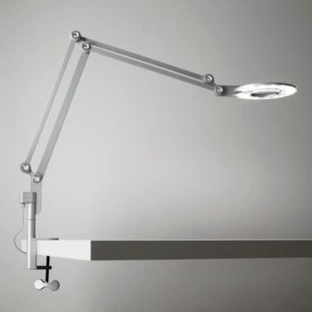 The Link Clamp is a modern task lamp with a circular LED light head that clamps to the edge of a desk and features an adjustable arm.