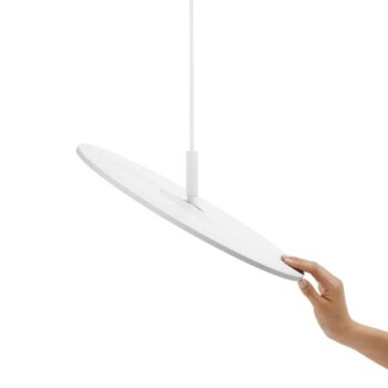 A hand adjusts the angle of a white, circular pendant light, named Circa Floor, hanging from a cable.