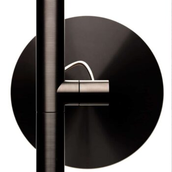 Close-up of the Brazo Floor, a black and silver wall-mounted fixture with a circular base and cylindrical arm against a white background.
