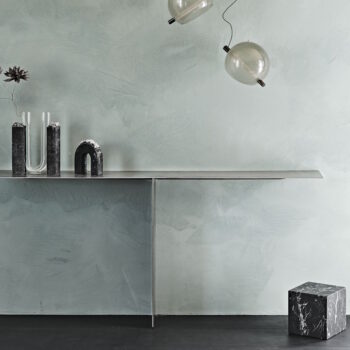 tee console table with minimal lines and industrial design in a modern open-plan living space