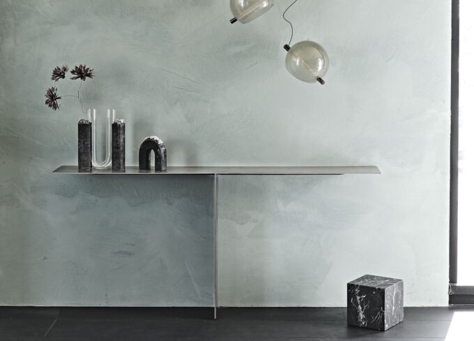 tee console table with minimal lines and industrial design in a modern open-plan living space