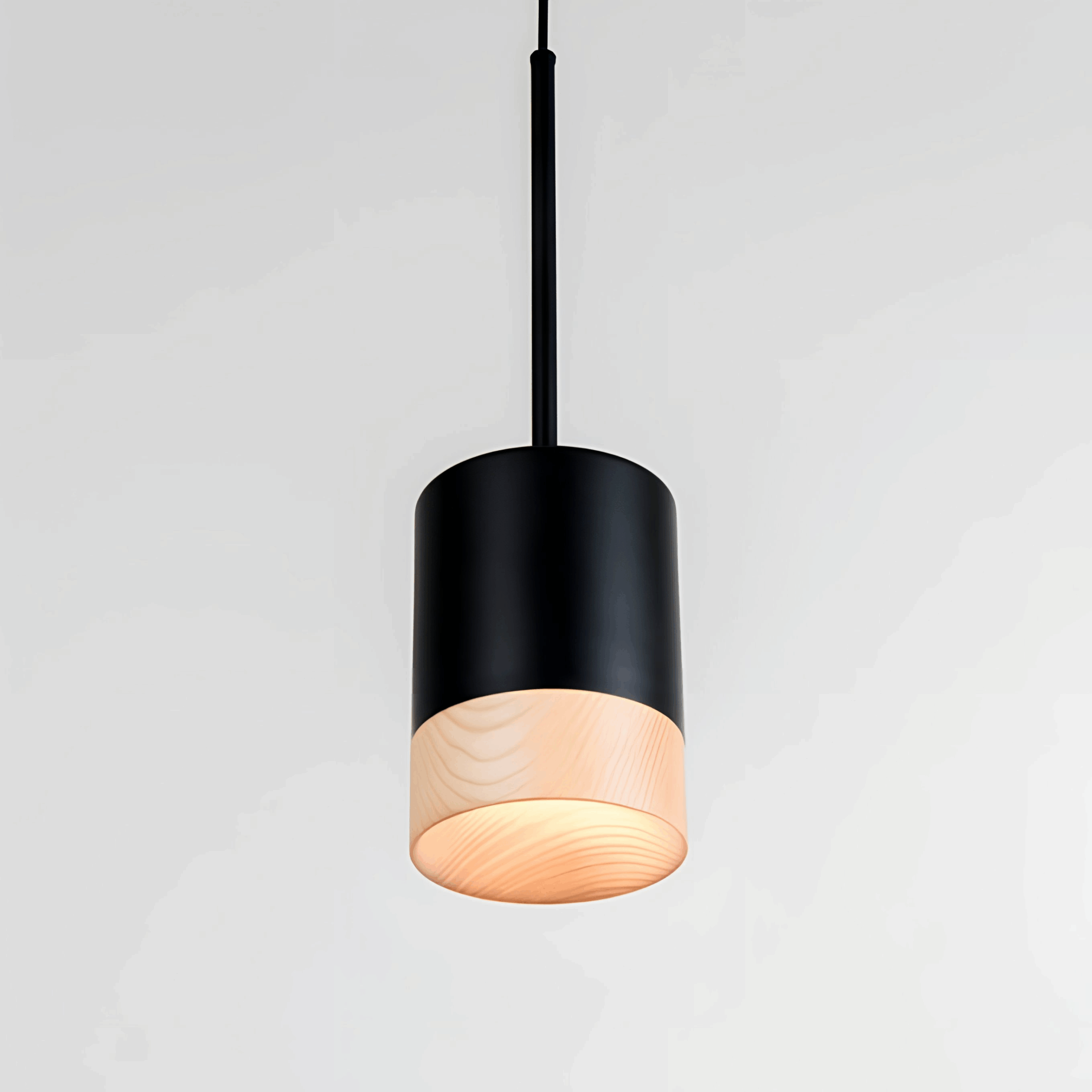 A modern black pendant light with a wood-textured accent on the lower half, perfect for creating warm ambient lighting, hangs from a black cord against a plain white background.