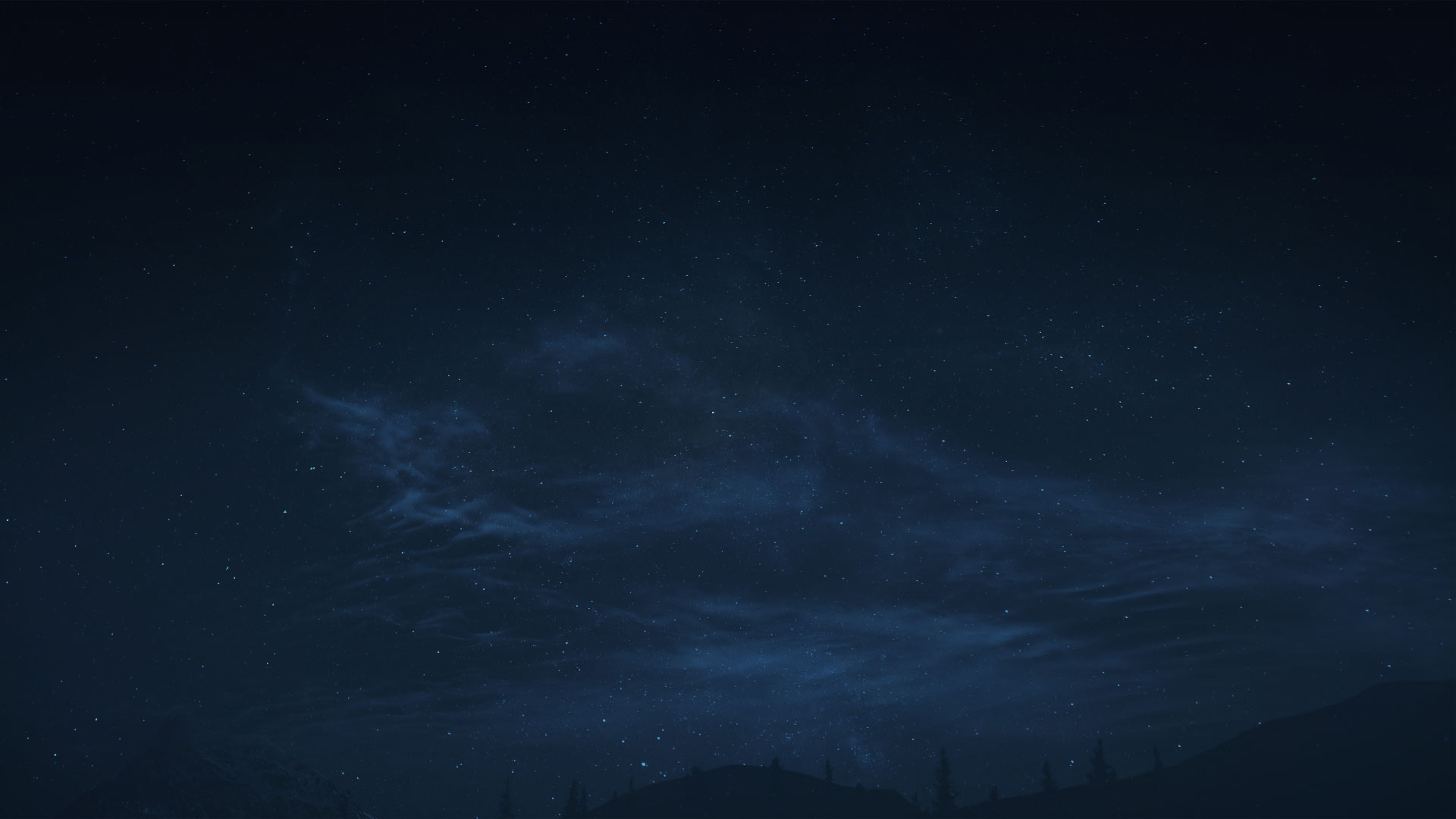Night sky with scattered stars and faint clouds above a dark silhouette of hills and trees.