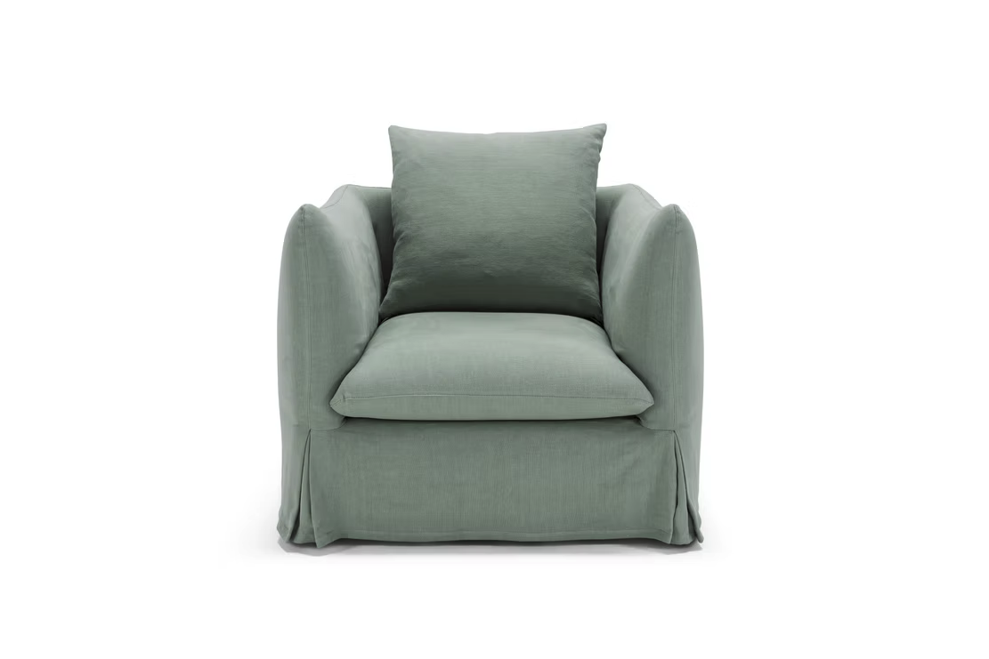 The Dylan Sofa is a sage green upholstered piece with a matching cushion, wide seat, and skirted base, displayed from the front against a white background.