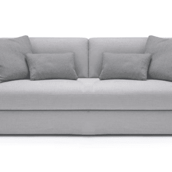 The John John Sofa is an large 2 seater with cushions and a left-side chaise, upholstered in light beige fabric, shown on a white background.