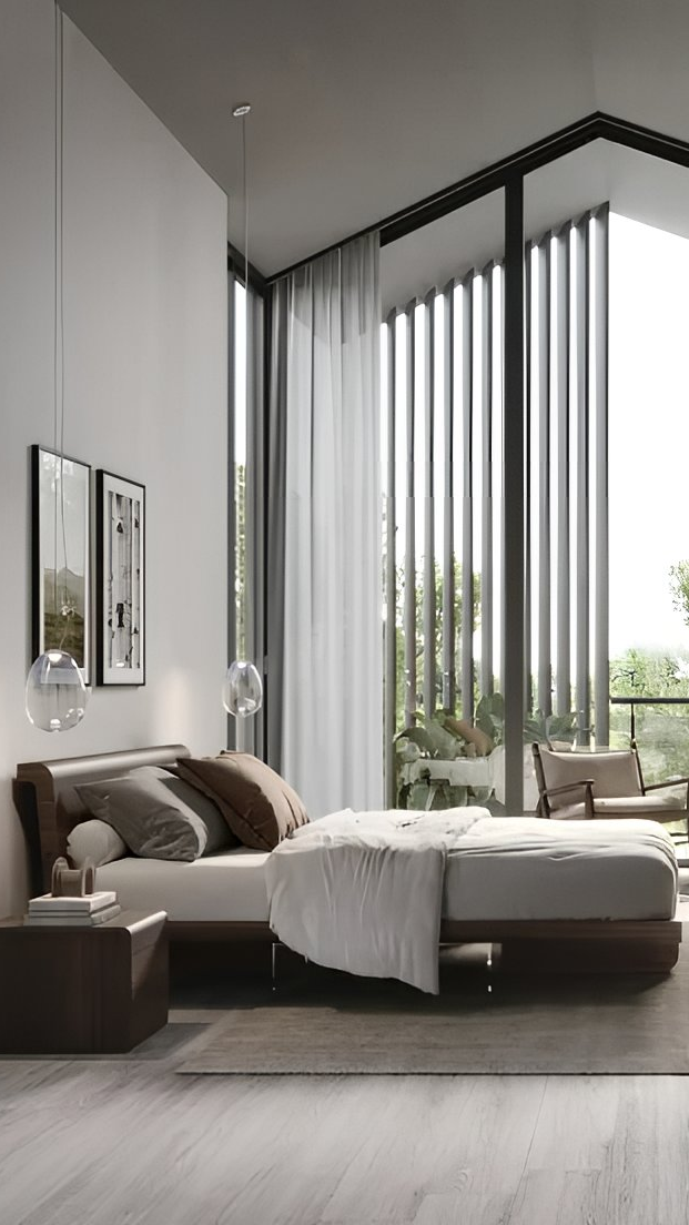 Modern bedroom decor with a double bed, neutral bedding, large floor-to-ceiling windows, sheer curtains, pendant lights, minimal furniture, and an outdoor view with greenery—perfect to furnish a bedroom in style.
